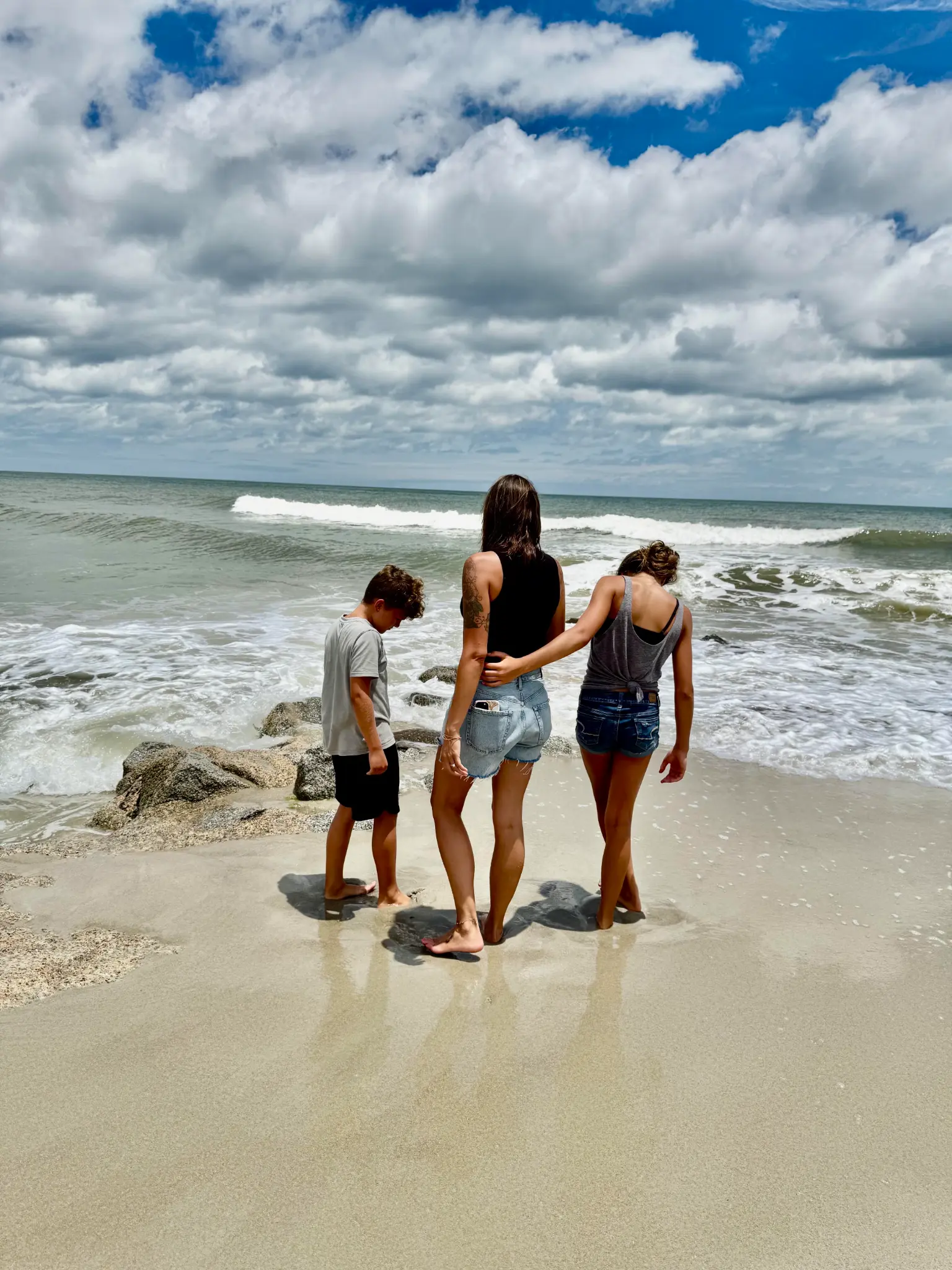 Corina at the beach with her two children