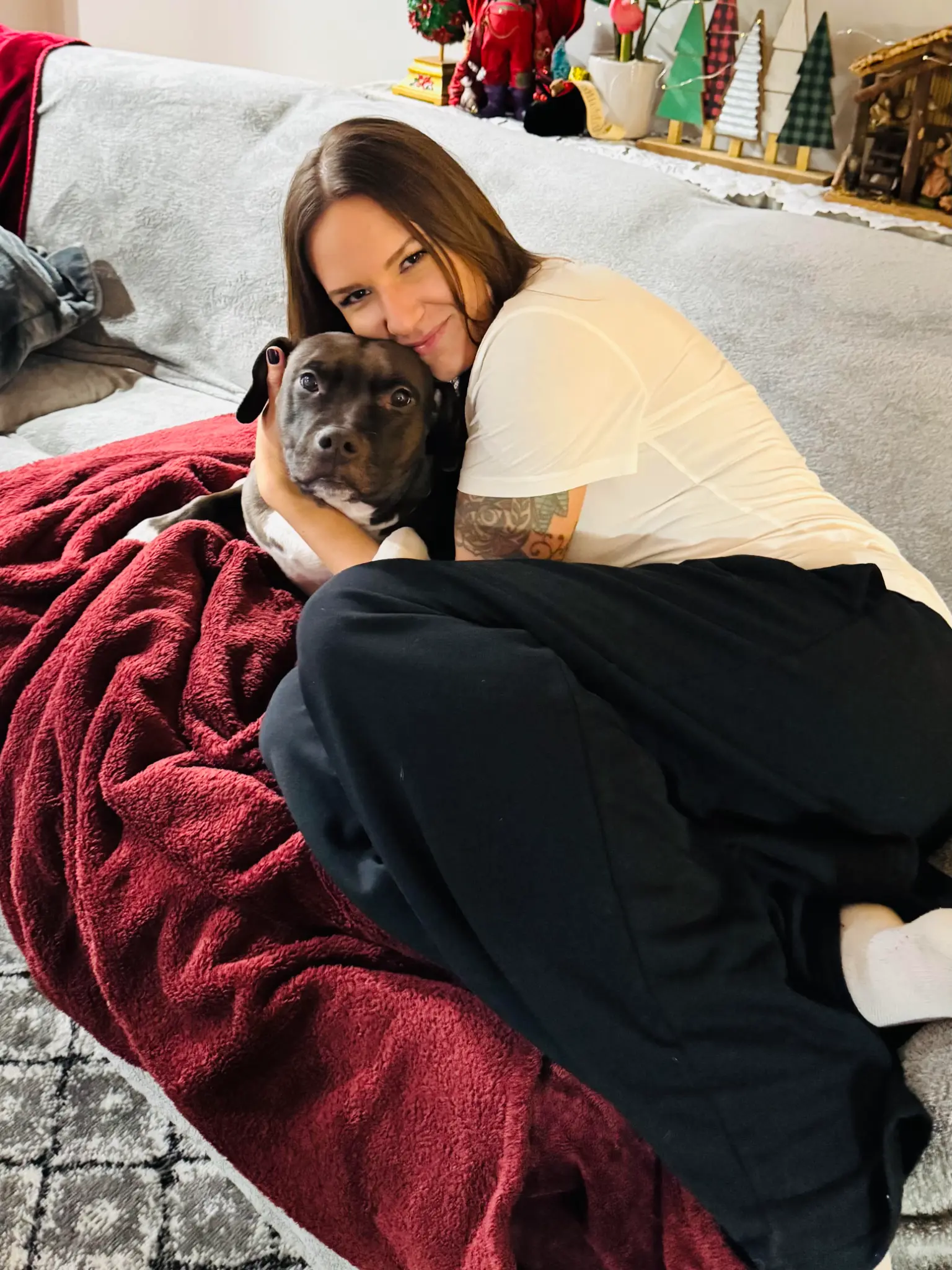 Corina hugging her dog at home