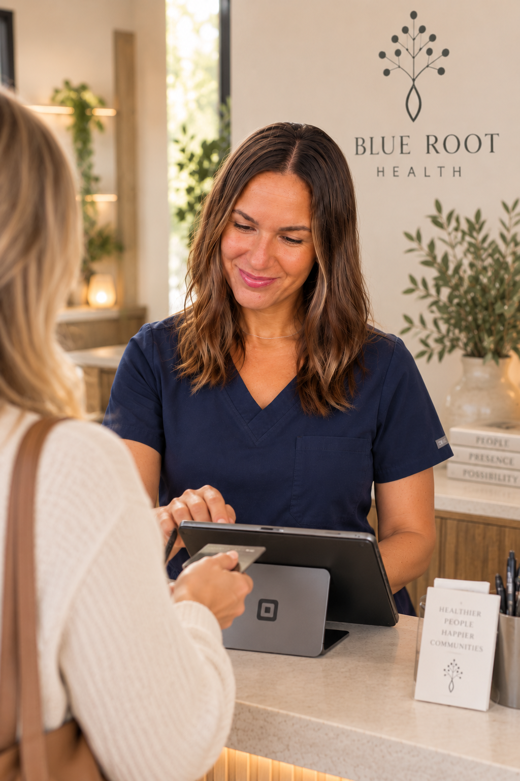 Corina helping a Blue Root patient at the reception counter