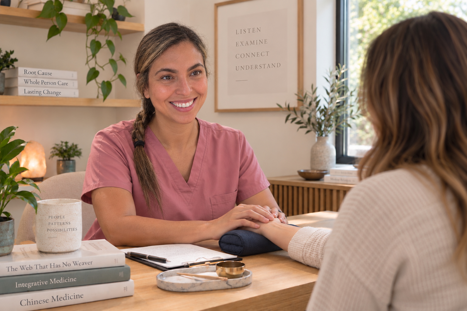 Blue Root practitioner listening to a patient while examining her pulse